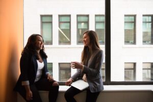 A mental health first aider discusses issues with a colleague